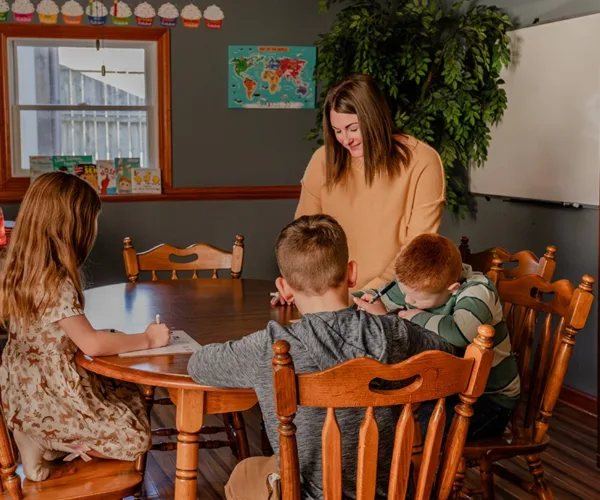 Teacher-with-children-writing